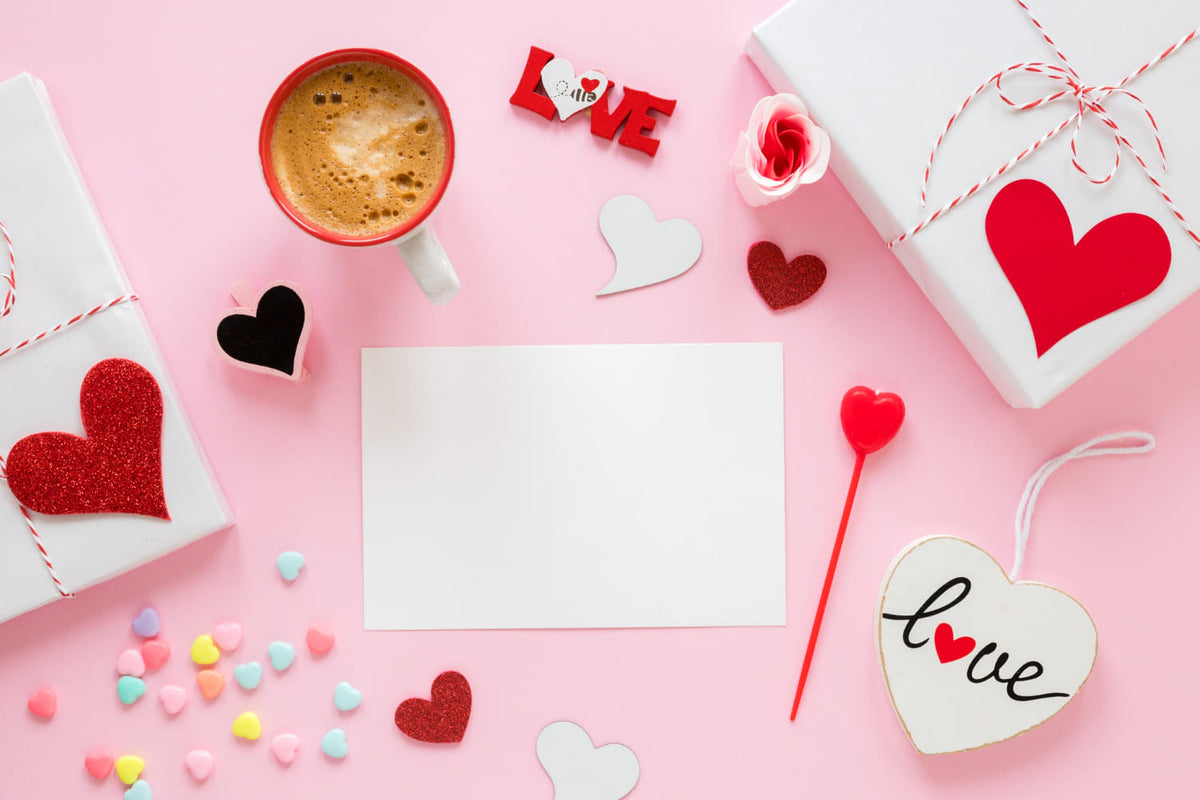 A romantic Valentine's Day flat-lay with a coffee cup, hearts, and a blank stationery card ready for a personalized gift card message for Valentine's from SARAH'S WHISPER.