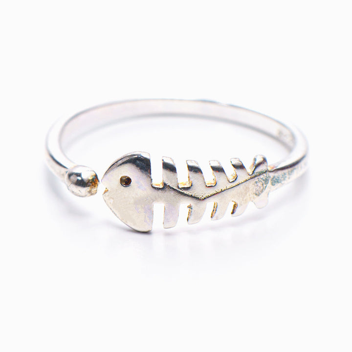 Fishbone ring with small fish design on white background