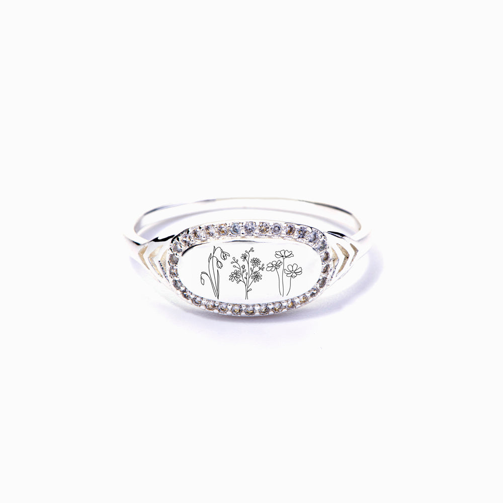 Birth flower jewelry ring on white background, close-up of flower design.