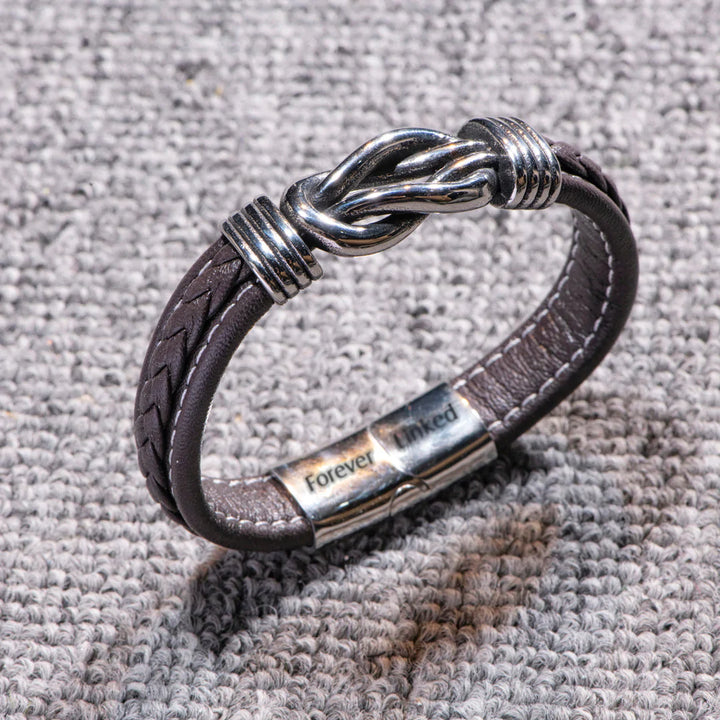 Detailed close-up of the engraving on the leather grandson bracelet.