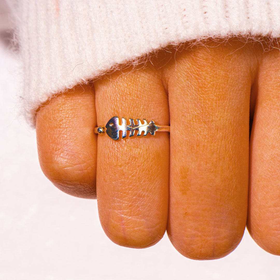 Person wearing adjustable fishbone ring hand shot