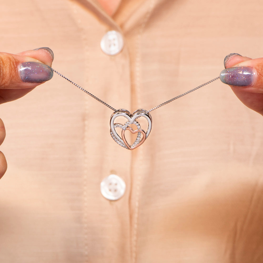 Detailed close-up of the engraved text on the grandma and granddaughter necklace.