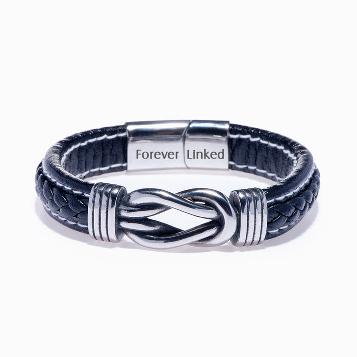 Son bracelet from mom on white background, close-up of leather braid.
