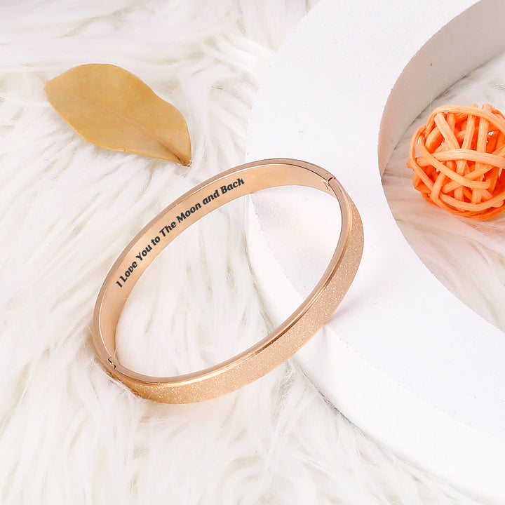 Close-up detail of love message on daughter bracelet  