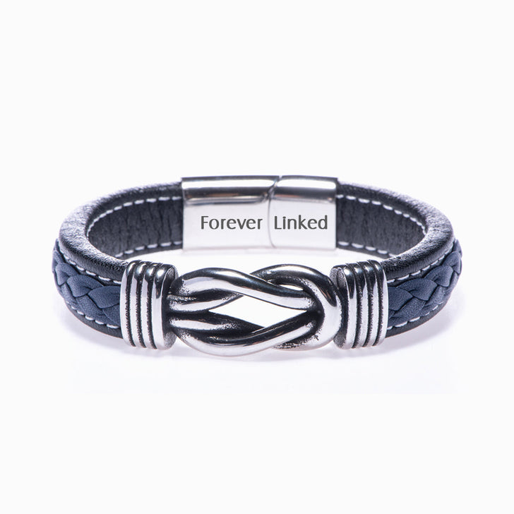 Son bracelet from mom on white background, close-up of leather braid.