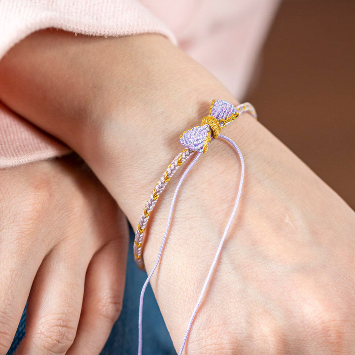 Knitted bowknot bracelet with an inspirational message. Perfect for wishing luck and support. The image depicts a stylish bracelet adorned with a bowknot, symbolizing encouragement and well-wishes for the wearer's journey