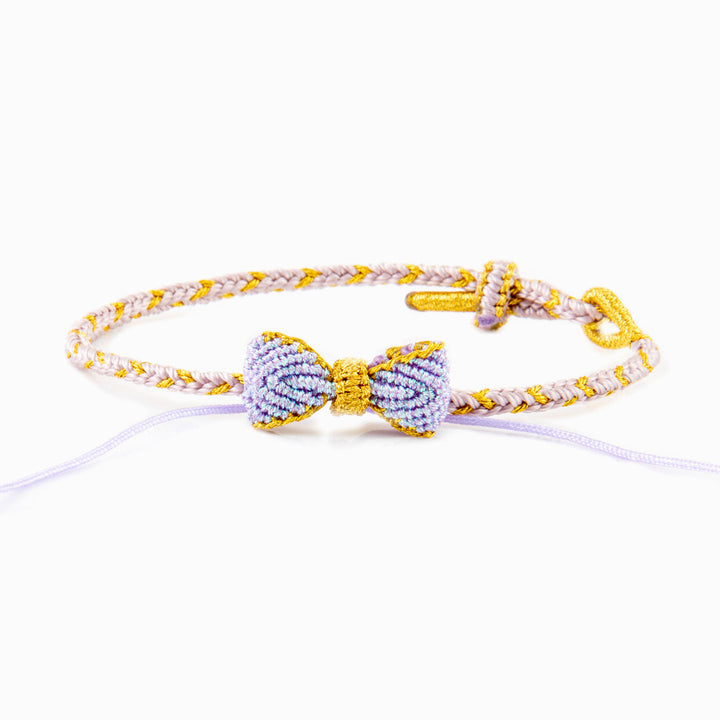 Knitted bowknot bracelet with an inspirational message. Perfect for wishing luck and support. The image depicts a stylish bracelet adorned with a bowknot, symbolizing encouragement and well-wishes for the wearer's journey