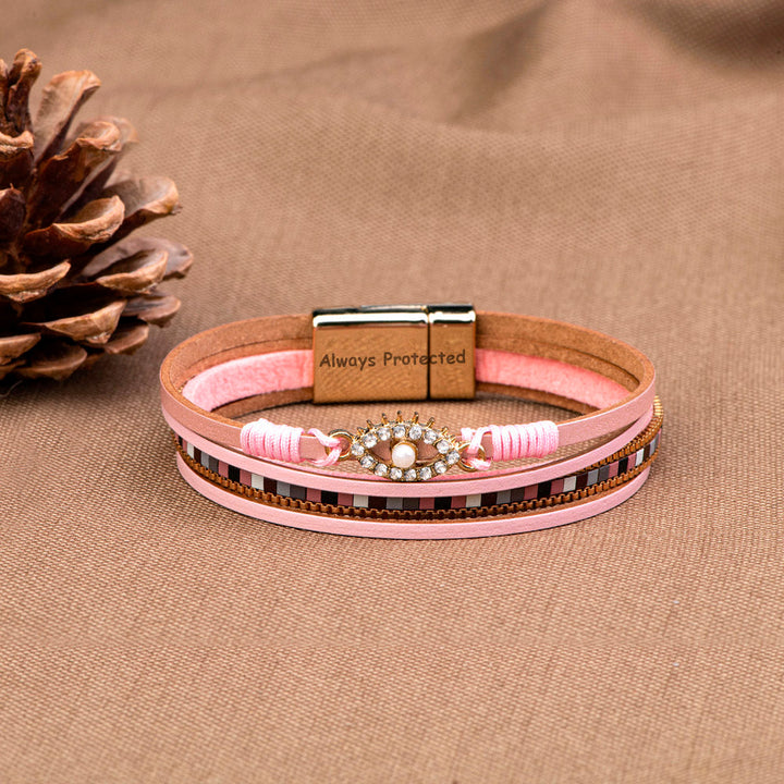 Protection Bracelet featuring PU leather, pearl, and rhinestones, symbolizing safety and elegance.