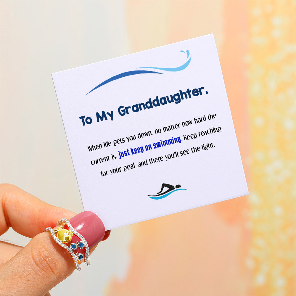 Granddaughter wearing bubble fish ring hand shot
