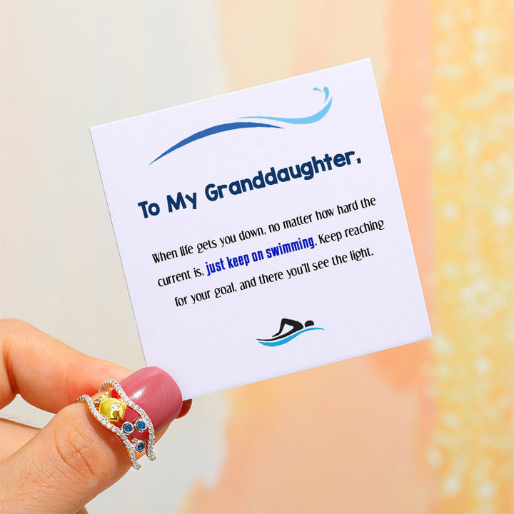 Granddaughter wearing bubble fish ring hand shot
