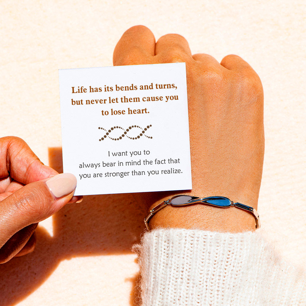 "'Life has its bends and turns' Twist Bracelet featuring symbolic ornament and motivational card, crafted from copper with plating techniques."
