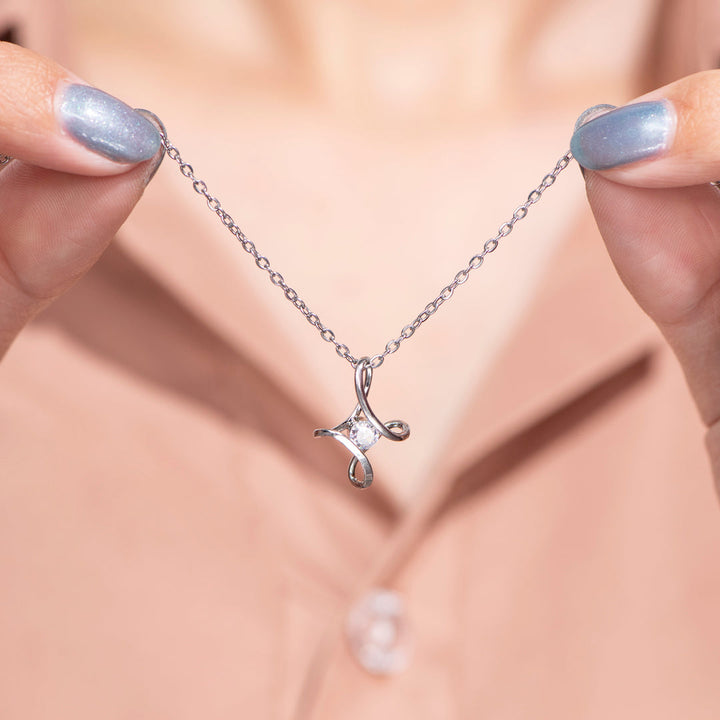 Close up detail of heart cross pendant for Mother's Day