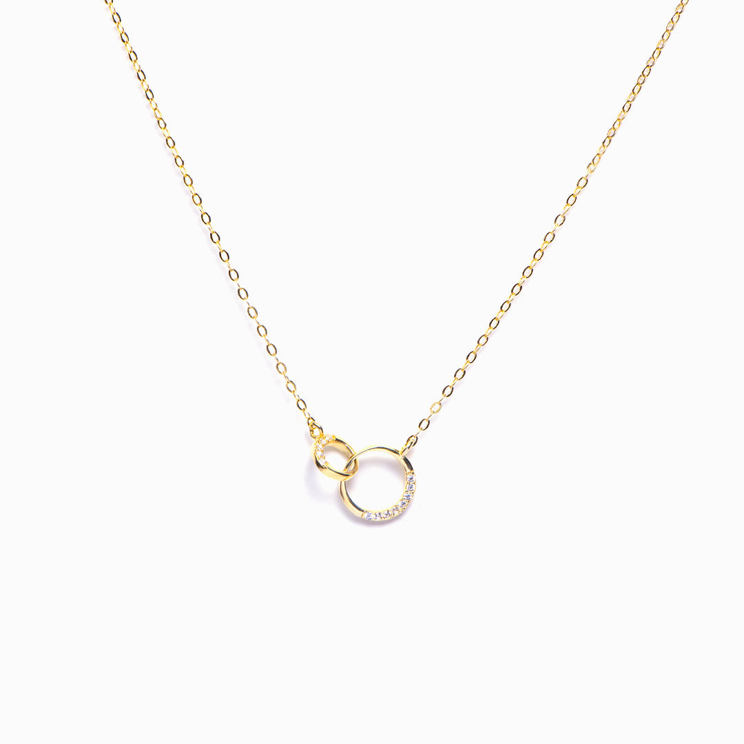 Double ring necklace for granddaughter on white background, showcasing elegant design and polished finish.