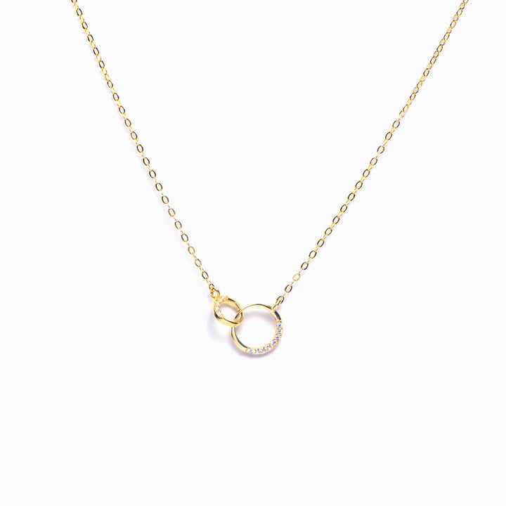 Double ring necklace for granddaughter on white background, showcasing elegant design and polished finish.