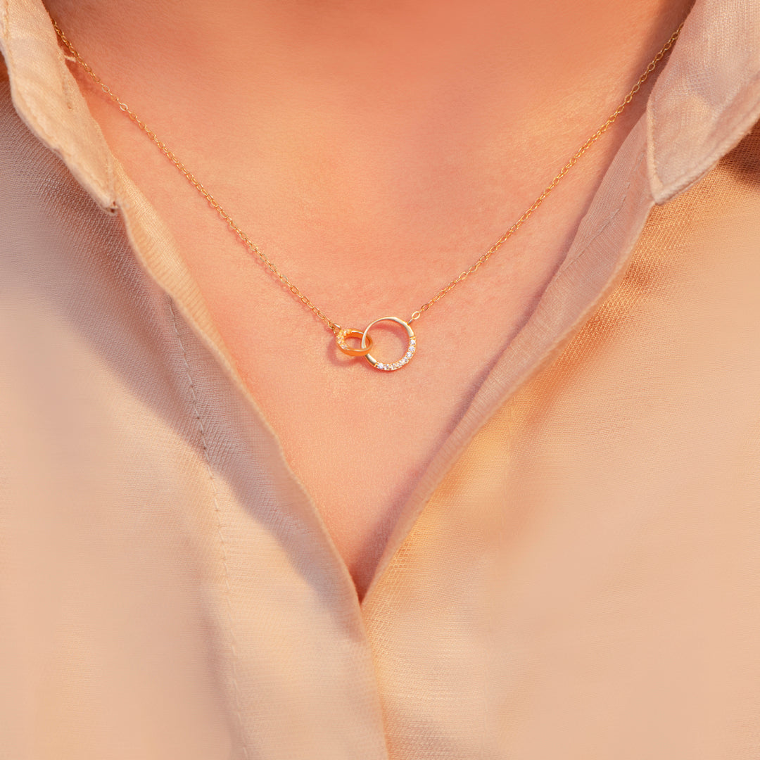 Double ring necklace for granddaughter worn elegantly, demonstrating its versatility and sentimental appeal.
