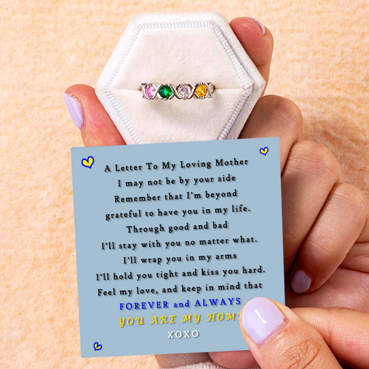 Gift card with heartfelt message beside Mother's Ring